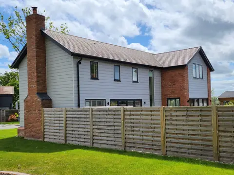 Cladding alongside brickwork — CG Cladding Solutions