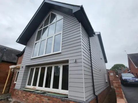 Pale cladding around a glazed gable — CG Cladding Solutions