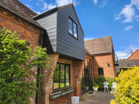 Front projection viewed from the garden — CG Cladding Solutions