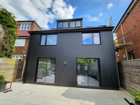 Completed dark vertical cladding — CG Cladding Solutions